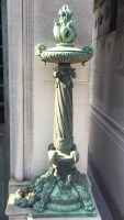 standing copper torch with flame on mausoleum
