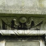 Egyptian winged disc symbol on victorian cemetery mausoleum tomb